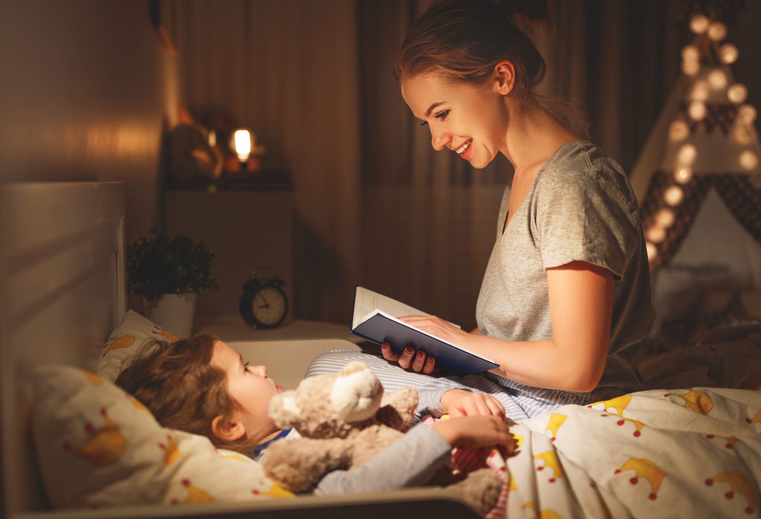 Mother,And,Child,Daughter,Reading,Book,In,Bed,Before,Going